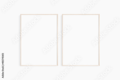 Frame mockup 5x7, 50x70, A4, A3, A2, A1. Set of two thin light wood frames. Gallery wall mockup, set of 2 frames. Clean, modern, minimalist, bright. Portrait. Vertical.