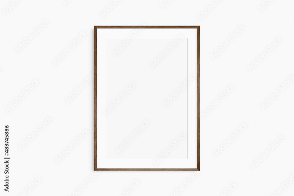 Frame mockup 5x7, 50x70, A4, A3, A2, A1. Single dark brown walnut wood frame mockup. Clean, modern, minimalist, bright. Portrait. Vertical. Passepartout/mat opening in 2:3 aspect ratio. Frame mockup 5x7, 50x70, A4, A3, A2, A1. Single dark brown walnut wood frame mockup. Clean, modern, minimalist, bright. Portrait. Vertical. Passepartout/mat opening in 2:3 aspect ratio.