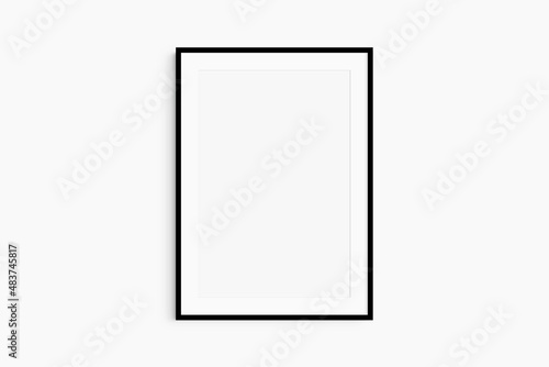 Frame mockup 5x7, 50x70, A4, A3, A2, A1. Single black frame mockup. Clean, modern, minimalist, bright. Portrait. Vertical. Passepartout/mat opening in 2:3 aspect ratio.