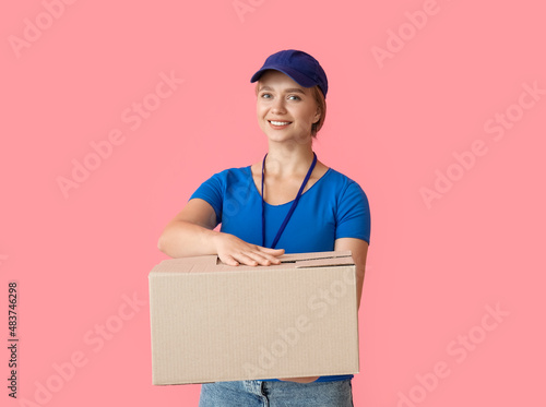 Female courier with parcel on color background