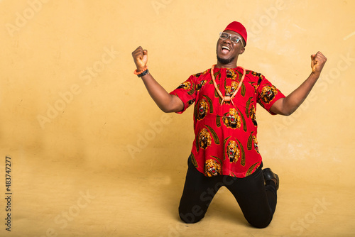 Igbo Traditionally Dressed Business Man Celebrate Kneeling down