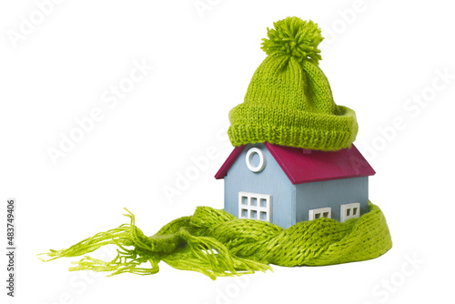 House in a Warm Knitted Green Cap and a Scarf