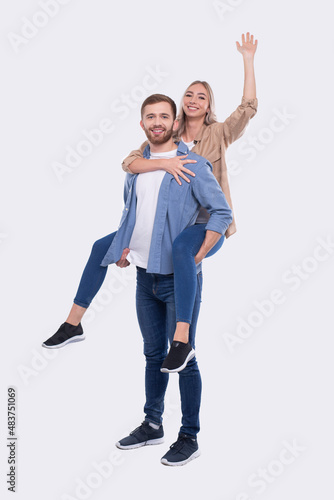 Girl Riding Man Back. Man Holding Girl. Couple Isolated. Girl on Man Back Sitting Hand Up. Love