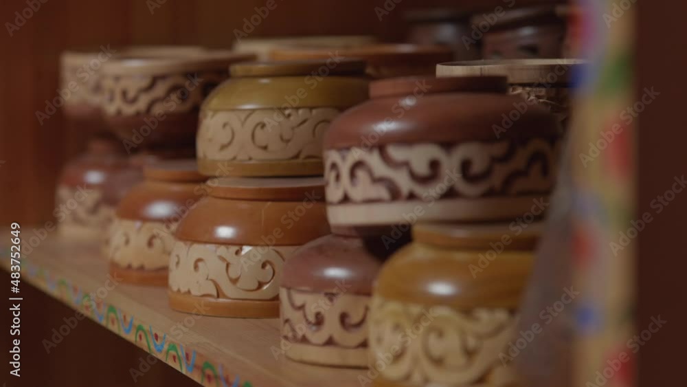 Central asian style carved wooden bowls on a shelf. Central asian style carved wooden bowls on a shelf.