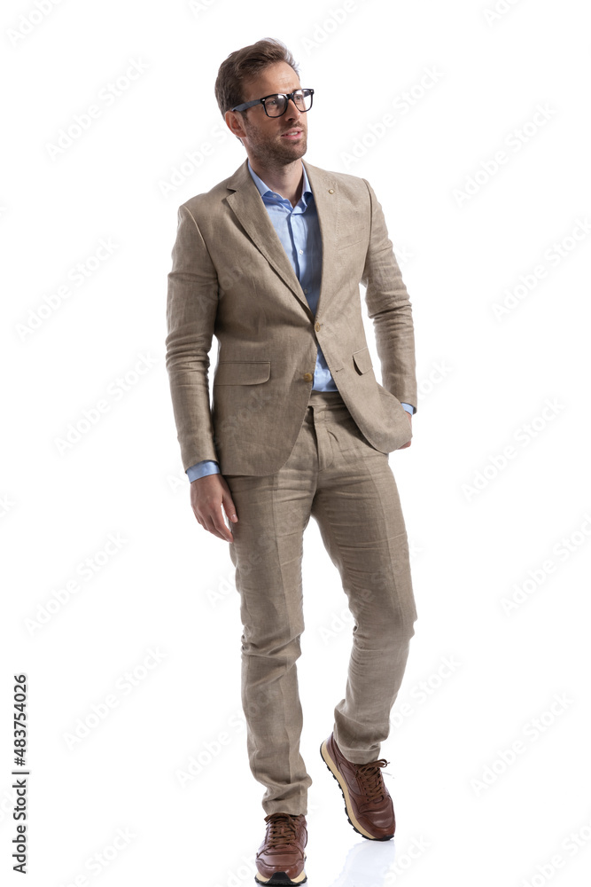 attractive businessman stepping forward with one hand in pocket attractive businessman stepping forward with one hand in pocket