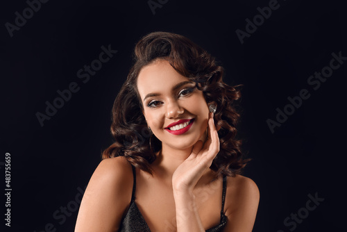 Wallpaper Mural Portrait of beautiful smiling woman with hand near face on dark background Torontodigital.ca