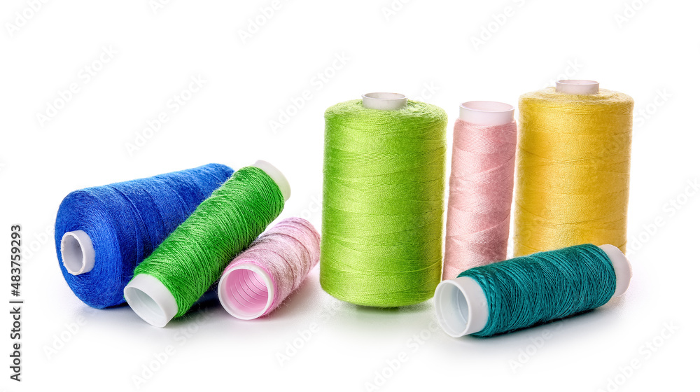 Different sewing thread spools on white background Different sewing thread spools on white background