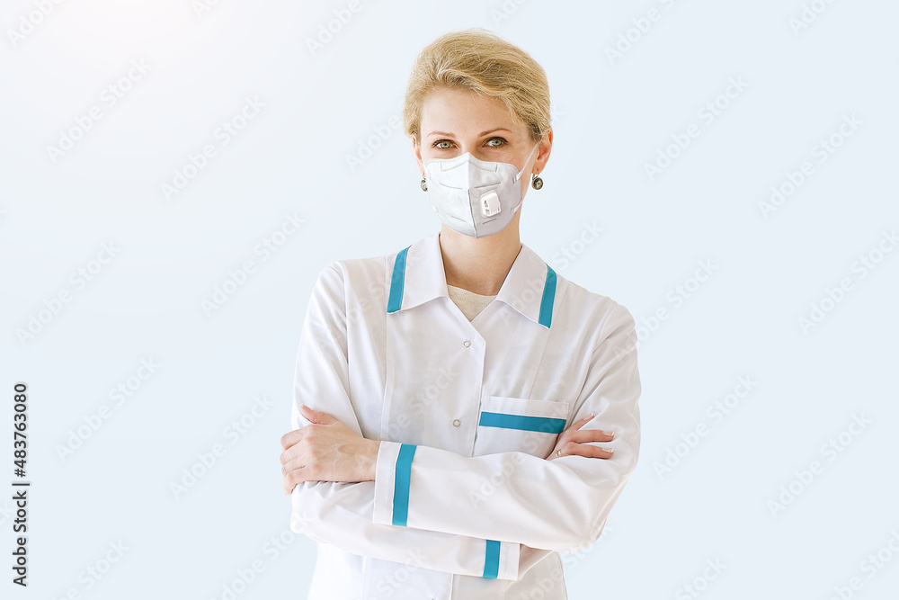 Healthcare, medical: Portrait doctor in wearing FFP2 face mask during Coronavirus Covid-19 infection pandemic isolated over grey color background Healthcare, medical: Portrait doctor in wearing FFP2 face mask during Coronavirus Covid-19 infection pandemic isolated over grey color background