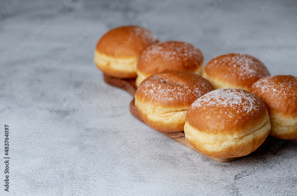 Donut Delights: Savoring Austrian Krapfen and German Berliner's Creamy Centered Wonders. On white table. Selective focus