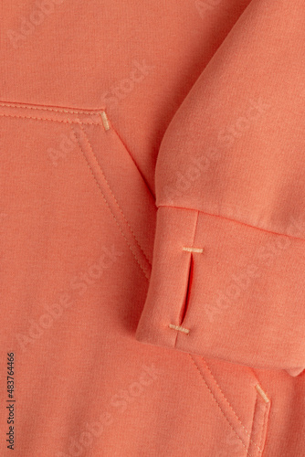 Hoodie texture. Close-up shot of sweatshirt hoodie brown textile warm fabric macro background. Pink color