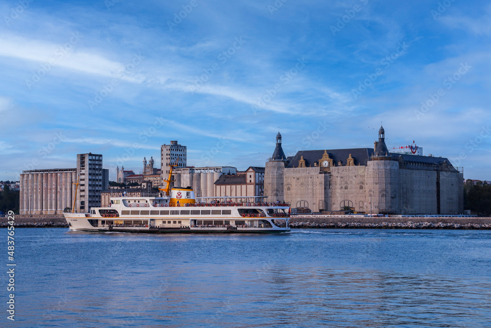 Haydarpaşa station is a railway station in Istanbul Turkey. Bosphorus with a beautiful blue turquoise sky background as the ferry passes in front of it.