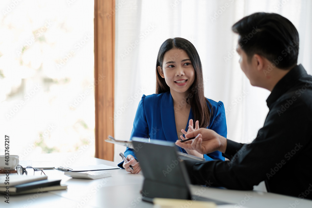 Two colleagues discussing data with document data on desk table. Close up business people meeting to discuss the situation on the market. Two colleagues discussing data with document data on desk table. Close up business people meeting to discuss the situation on the market.