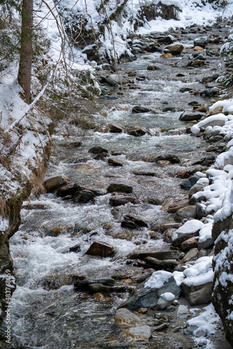 arctic landscape with a mountain creek at a cold winter day