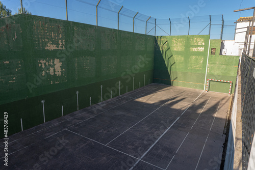 Empty fronton sports field, with worn green paint. photo