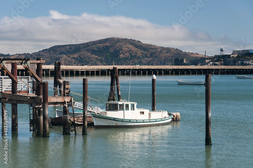 A fishing trawler docked at a wooden pier