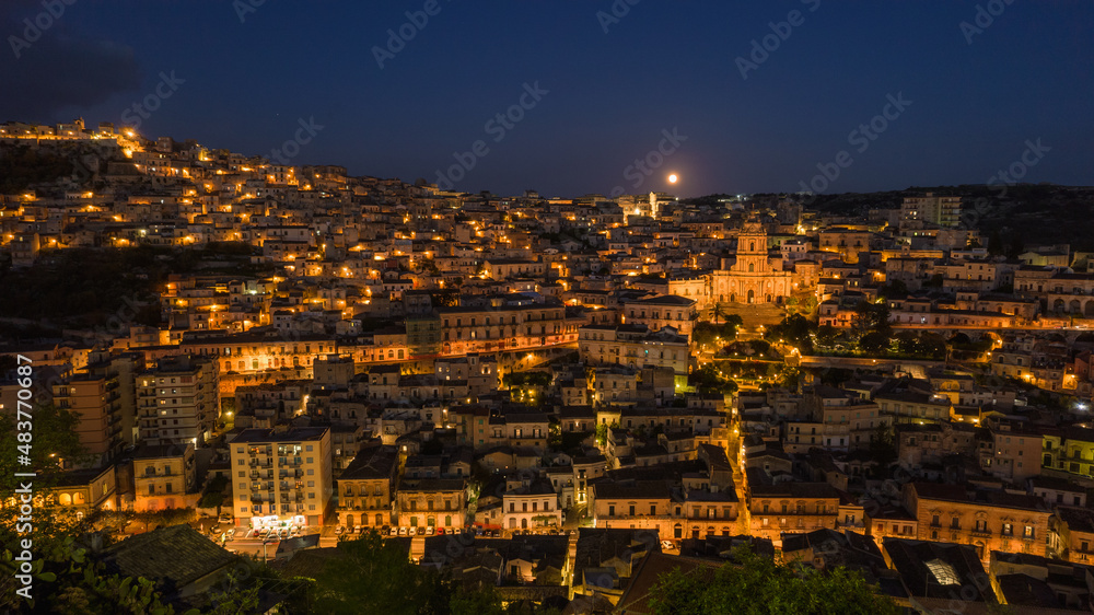 Aerial View of Modica City Centre at Night with the Lunar Eclipse, Ragusa, Sicily, Italy, Europe