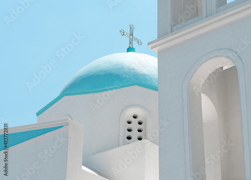 Church cross on top of roof on blue sky background photo