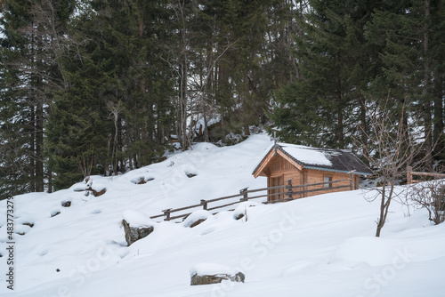 a traditional small wood chapel in the snow capped mountains in austria © Chamois huntress