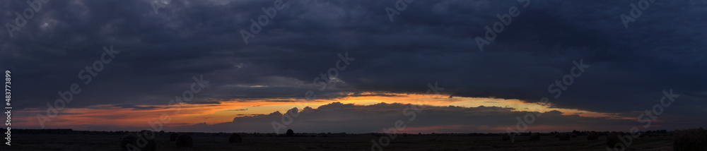 Landscape panorama with dark sky at sunset