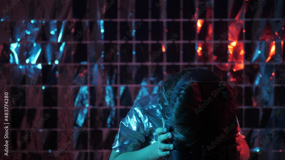 boy child in a silver shirt and glasses virtual reality playing a game. the color of cyberpunk is blue and red boy child in a silver shirt and glasses virtual reality playing a game. the color of cyberpunk is blue and red