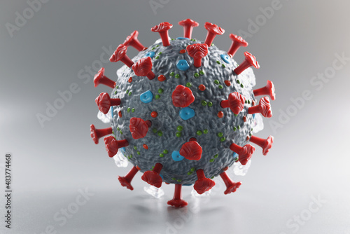Plastic model of coronavirus on a gray background photo
