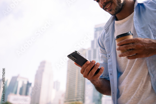 Businessman leadership using smartphone and dream with big project while relaxing outside near Great Bell of the striking clock at the north dreaming for bigger projects.
