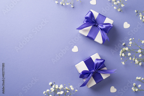 Top view photo of woman s day composition white gypsophila flowers two white gift boxes with violet bows and hearts on isolated pastel lilac background with empty space