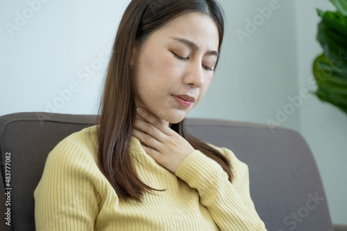 woman touch her neck and feeling a sore throat