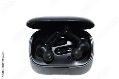 black wireless in-ear headphones in a case. isolation on white.