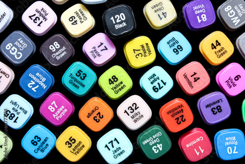 Set of colored markers. Color numbers on caps. Close-up.