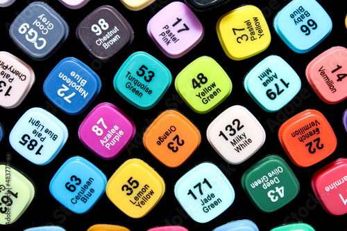 Set of colored markers. Color numbers on caps. Close-up.