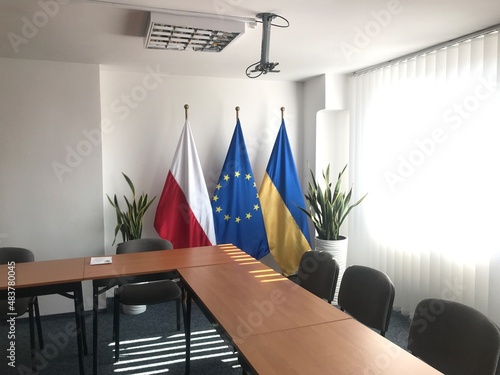 interior of a room with flags of Poland, European Union and Ukraine 