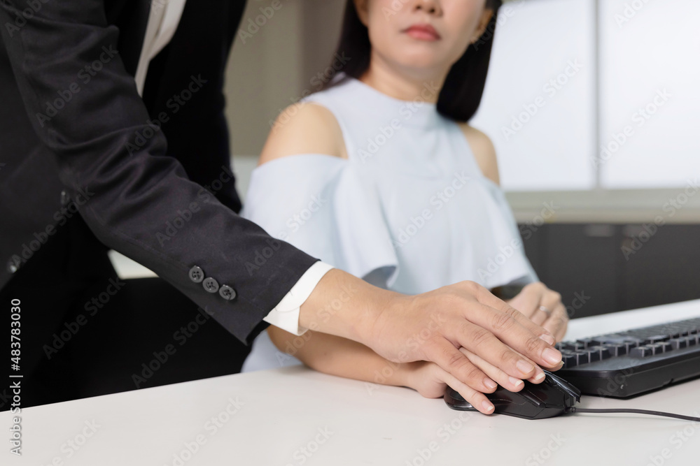 Asian Boss Touching His Secretary Hand on Computer Mouse in the Office For Oddice Sexual Harassment Concept Asian Boss Touching His Secretary Hand on Computer Mouse in the Office For Oddice Sexual Harassment Concept