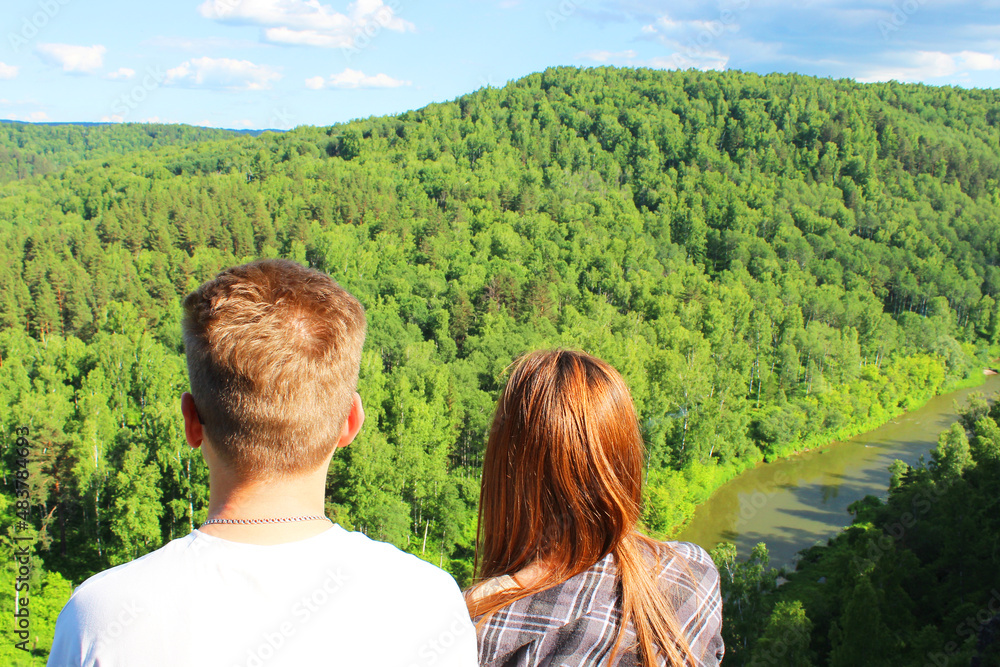 Couple sitting on a hill and holding hands Romantic scene of a young ...