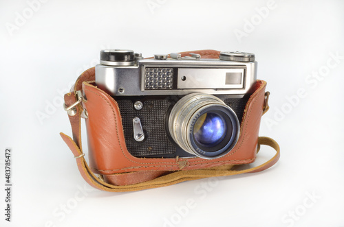 Old film camera in a leather case on a white background.
