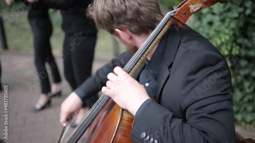 Male Violoncellist Playing The Cello In A String Quartet Outdoors photo