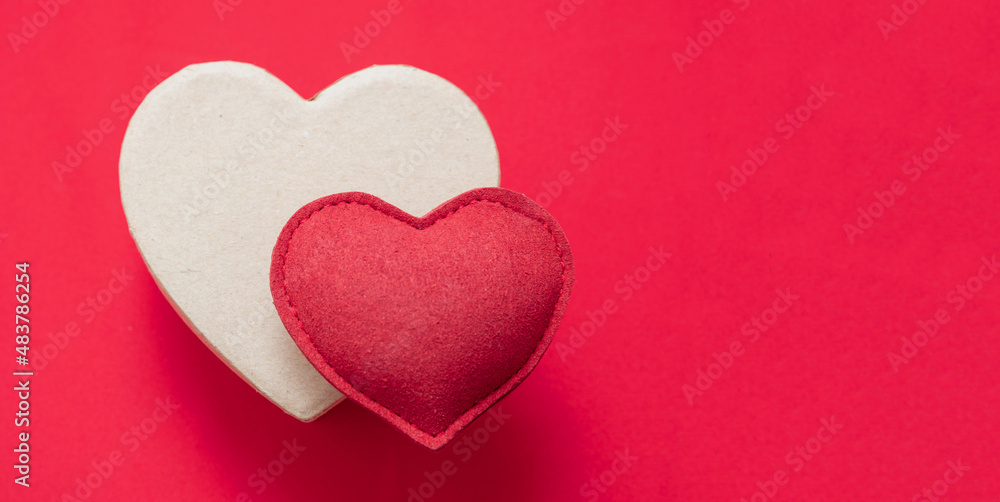 Valentine day felt texture heart on gift box, red background. Copy space.