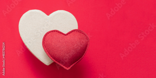 Valentine day felt texture heart on gift box  red background. Copy space.