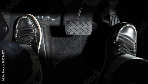 Accelerate and Brake. Foot pressing foot pedal of a car to drive ahead. Accelerator and brake pedal in a car. Driver driving the car by pushing accelerator pedals of the car. inside vehicle automobile photo