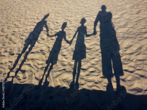 Shadows of a family at the beach