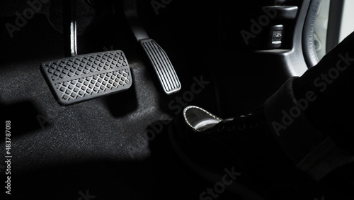 Accelerate and Brake. Foot pressing foot pedal of a car to drive ahead. Accelerator and brake pedal in a car. Driver driving the car by pushing accelerator pedals of the car. inside vehicle automobile photo