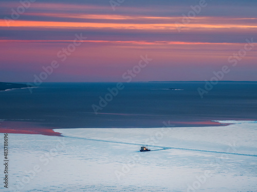 Scientific research vessel, breaks its way in the ice of the White Sea. View from above.