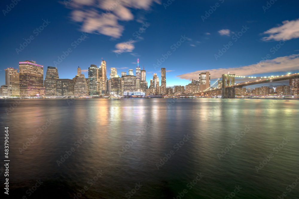 view of new york city skyline with brooklyn bridge and reflection on river - NYC, Brooklyn Heights, USA