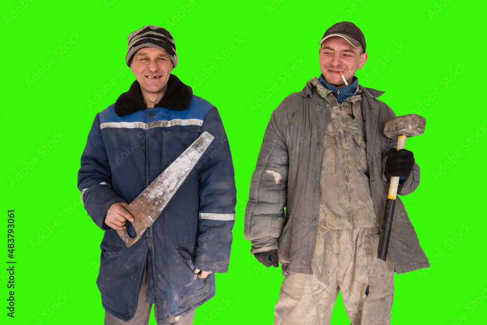 Two bad unskilled builder workers in bad dirty tattered uniform with bad tools. Concept of unskilled workers or crooks or poor quality workers Two bad unskilled builder workers in bad dirty tattered uniform with bad tools. Concept of unskilled workers or crooks or poor quality workers