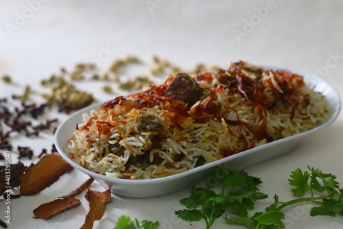 Mutton Biryani. A dish cooked with spices layered between mildly spiced ghee rice with a generous sprinkle of caramelized onions and Mutton marinated in yogurt photo