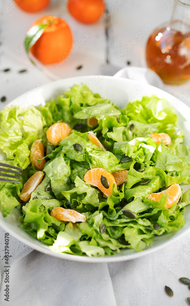Lettuce salad with tangerines, olive oil, pumpkin seeds Lettuce salad with tangerines, olive oil, pumpkin seeds