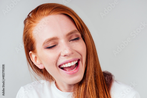attractive; redhaired ginger woman hearing the first sounds in her life.hearing correction photo