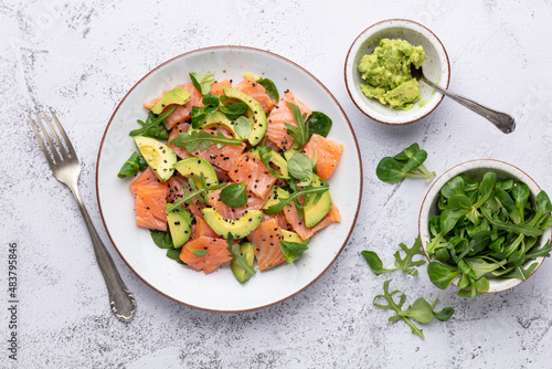 Fresh salmon salad with avocado,  for keto and low carb diet. Rusty background, top view, copy space.