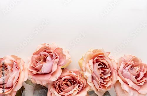 Flowers composition. Bouquet of pink roses in pastel colors. Flatlay.