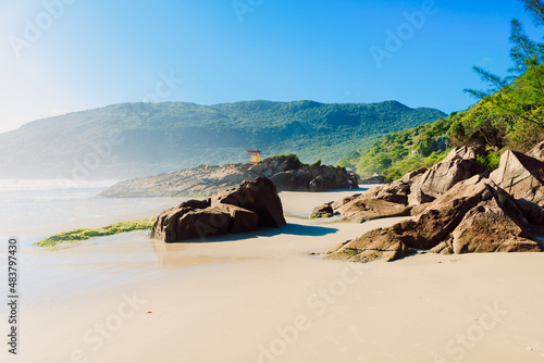 Matadeiro Beach with rocks, ocean and fog in sunny day in Brazil photo